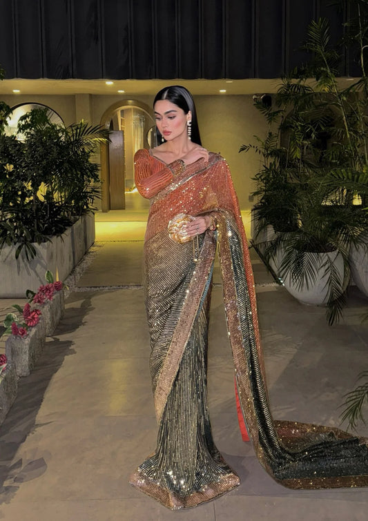 Elegant chiffon saree with printed and embroidered fall and pallu, paired with an embroidered chiffon blouse featuring organza neckline, borders, and a silk petticoat.