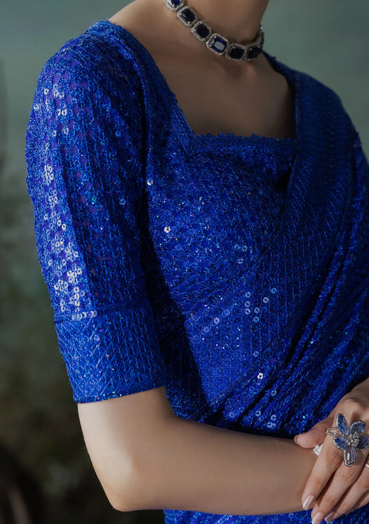 Elegant chiffon saree with embroidered fall and pallu, paired with an embroidered chiffon blouse featuring organza neckline and sleeve borders with silk petticoat.