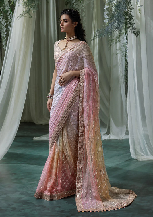 Graceful chiffon saree with printed and embroidered fall and pallu, paired with an embroidered chiffon blouse, organza borders, and a medium silk petticoat.