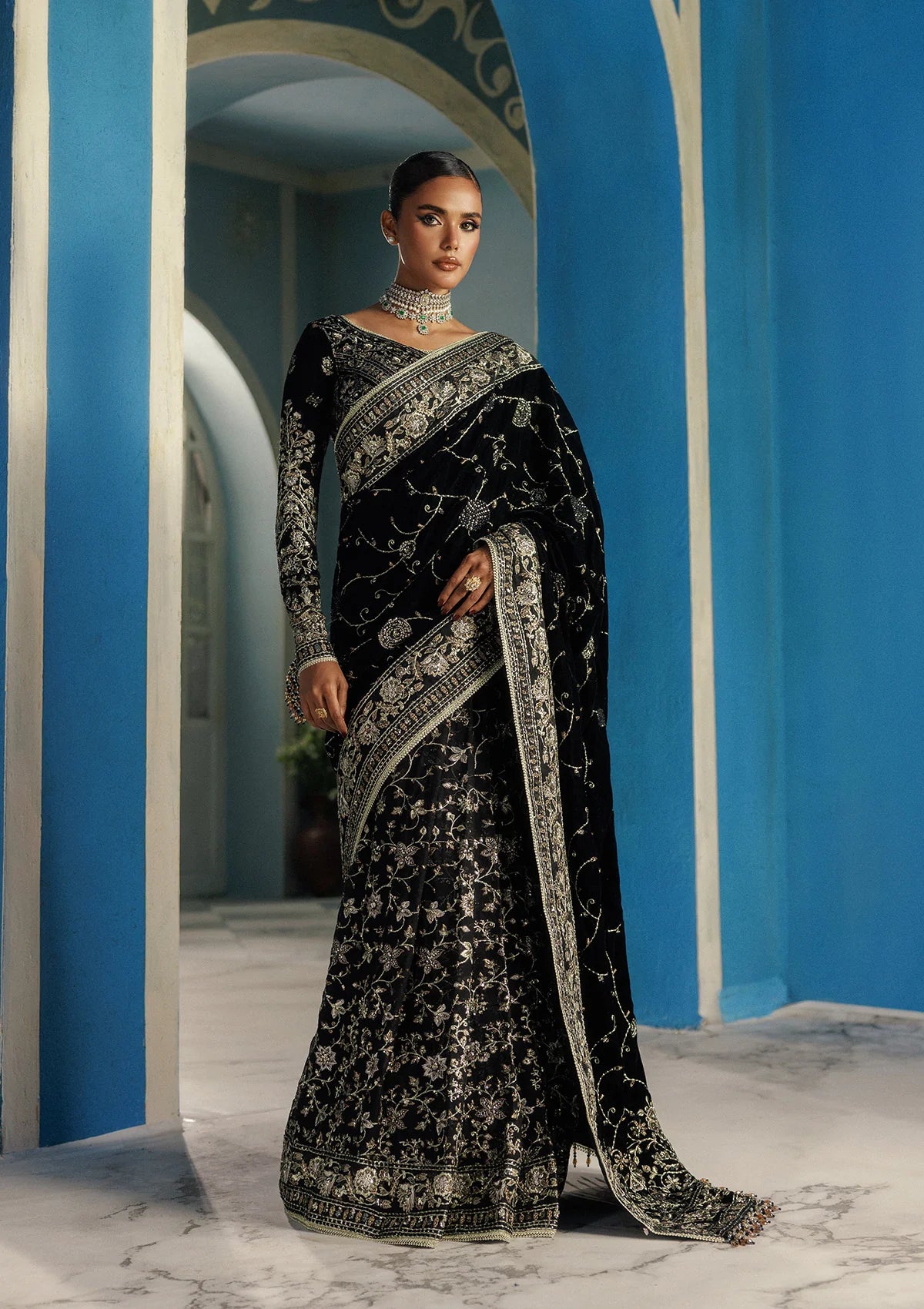 Elegant embroidered velvet blouse with organza detailing, paired with chiffon saree featuring velvet pallu, embroidered borders, and medium silk petticoat for festive occasions.