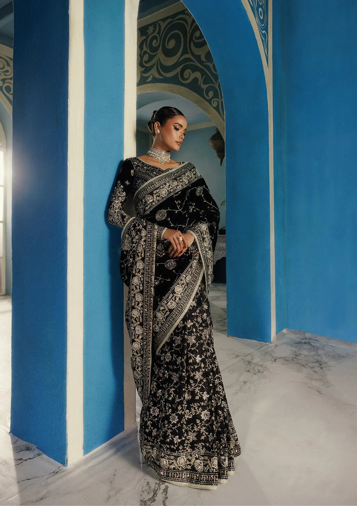 Elegant embroidered velvet blouse with organza detailing, paired with chiffon saree featuring velvet pallu, embroidered borders, and medium silk petticoat for festive occasions.