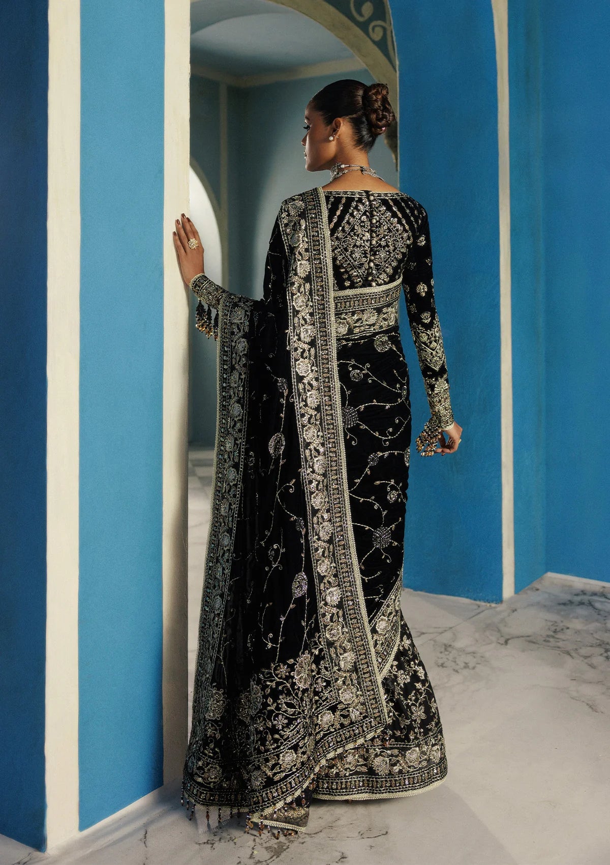 Elegant embroidered velvet blouse with organza detailing, paired with chiffon saree featuring velvet pallu, embroidered borders, and medium silk petticoat for festive occasions.