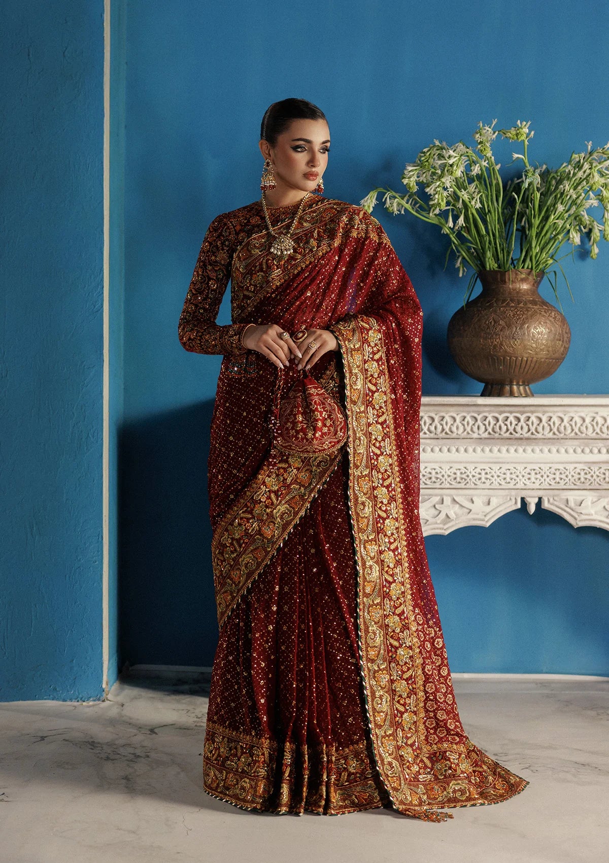 Elegant embroidered velvet blouse with organza detailing paired with chiffon saree featuring embroidered pallu, borders, and medium silk petticoat for festive wear.