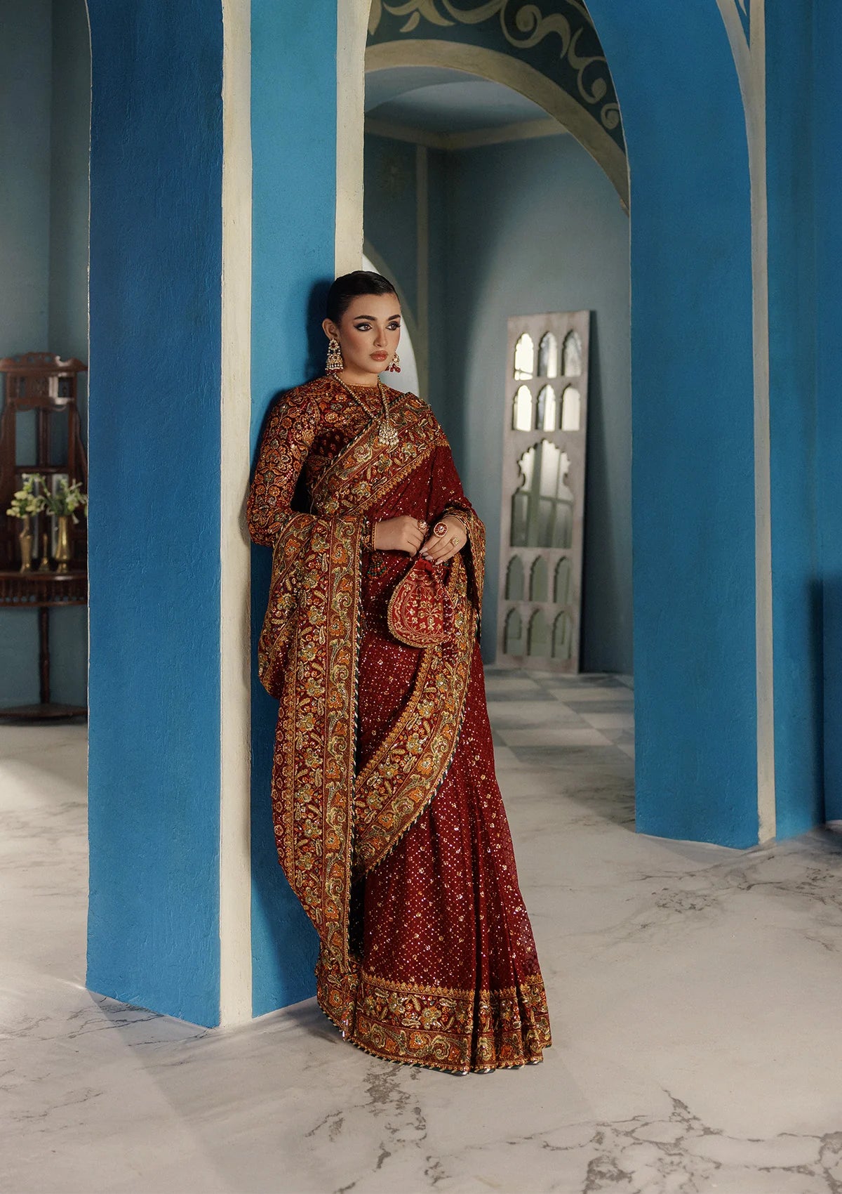 Elegant embroidered velvet blouse with organza detailing paired with chiffon saree featuring embroidered pallu, borders, and medium silk petticoat for festive wear.