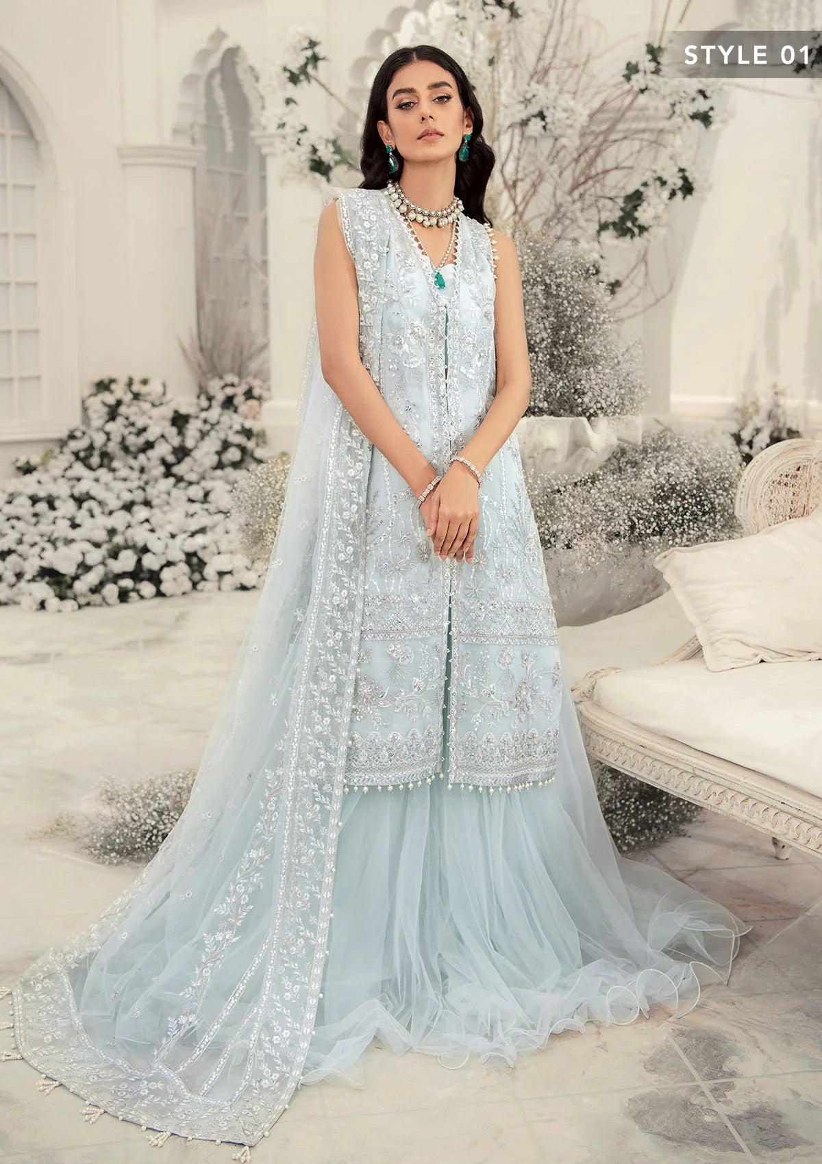 Elegant ice blue organza ensemble featuring hand embellishments, signature embroidery, silver sequins, pearl beadwork, raw silk pants, and an embroidered net dupatta for a refined pastel formal look.