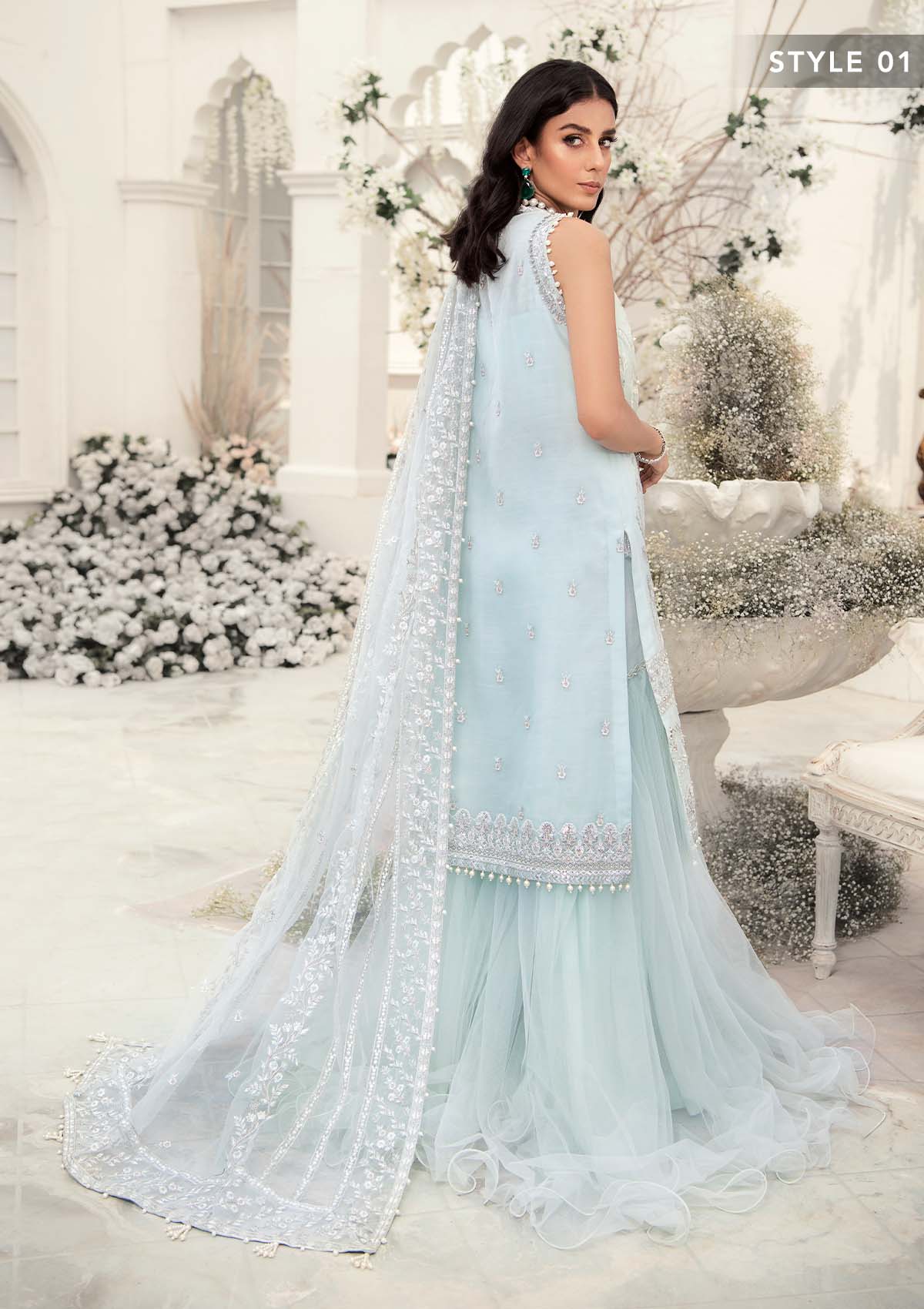 Elegant ice blue organza ensemble featuring hand embellishments, signature embroidery, silver sequins, pearl beadwork, raw silk pants, and an embroidered net dupatta for a refined pastel formal look.