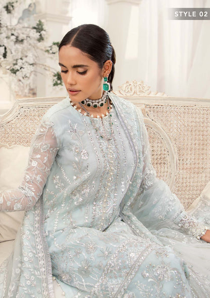 Elegant ice blue organza ensemble featuring hand embellishments, signature embroidery, silver sequins, pearl beadwork, raw silk pants, and an embroidered net dupatta for a refined pastel formal look.