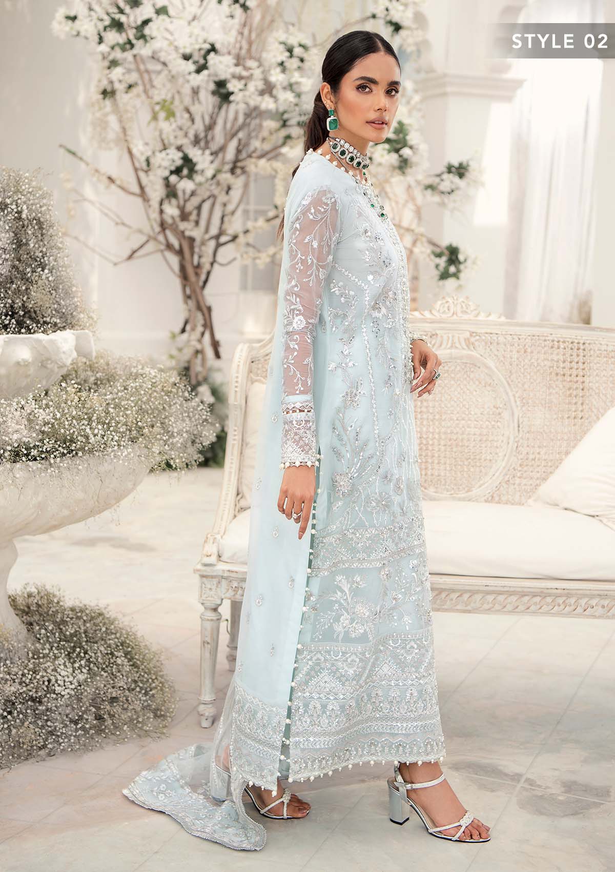 Elegant ice blue organza ensemble featuring hand embellishments, signature embroidery, silver sequins, pearl beadwork, raw silk pants, and an embroidered net dupatta for a refined pastel formal look.