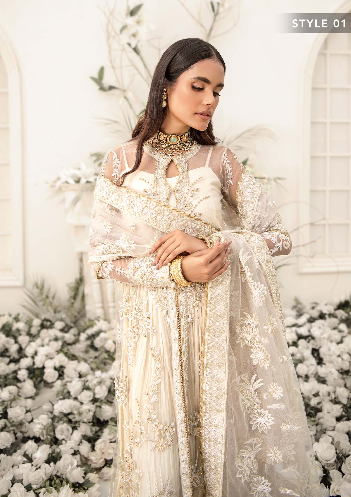Elegant ivory net outfit with hand-embellished floral motifs, gold dipped pearls, sequins, glass beads, raw silk pants and an embroidered net dupatta luxe.