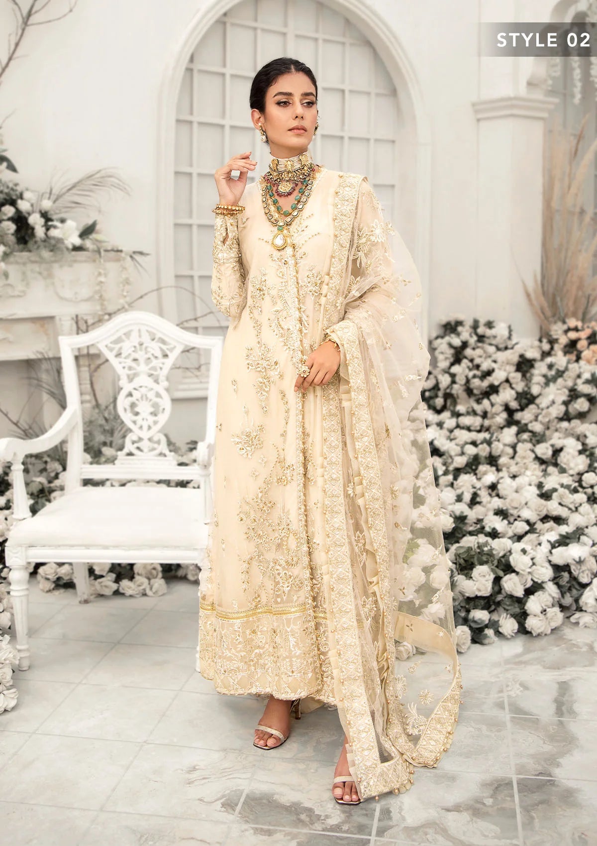 Elegant ivory net outfit with hand-embellished floral motifs, gold dipped pearls, sequins, glass beads, raw silk pants and an embroidered net dupatta luxe.