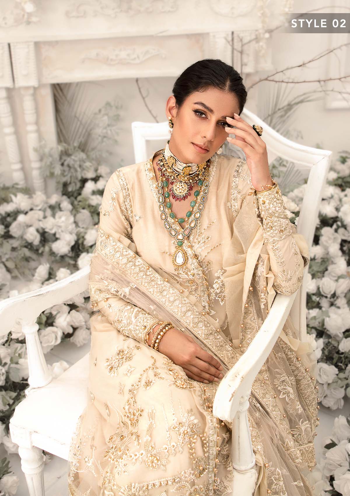 Elegant ivory net outfit with hand-embellished floral motifs, gold dipped pearls, sequins, glass beads, raw silk pants and an embroidered net dupatta luxe.