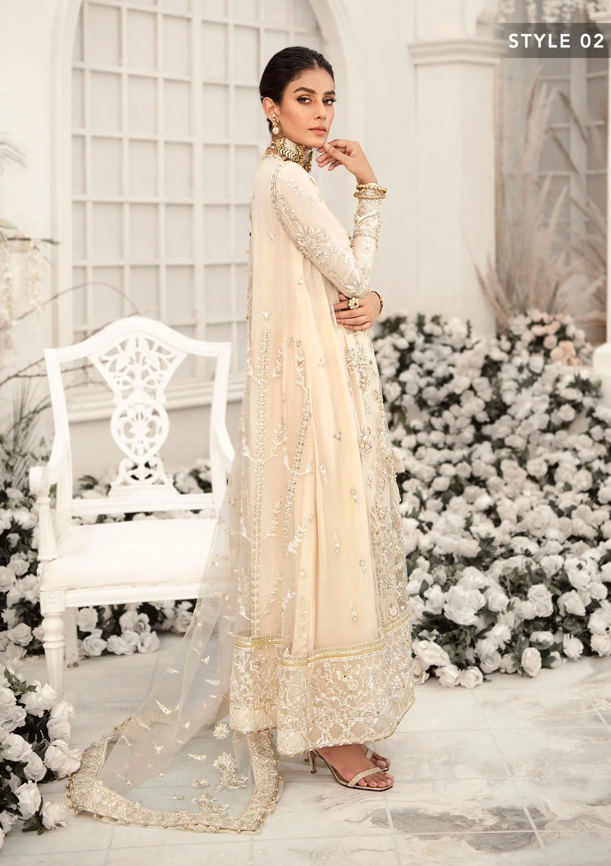 Elegant ivory net outfit with hand-embellished floral motifs, gold dipped pearls, sequins, glass beads, raw silk pants and an embroidered net dupatta luxe.