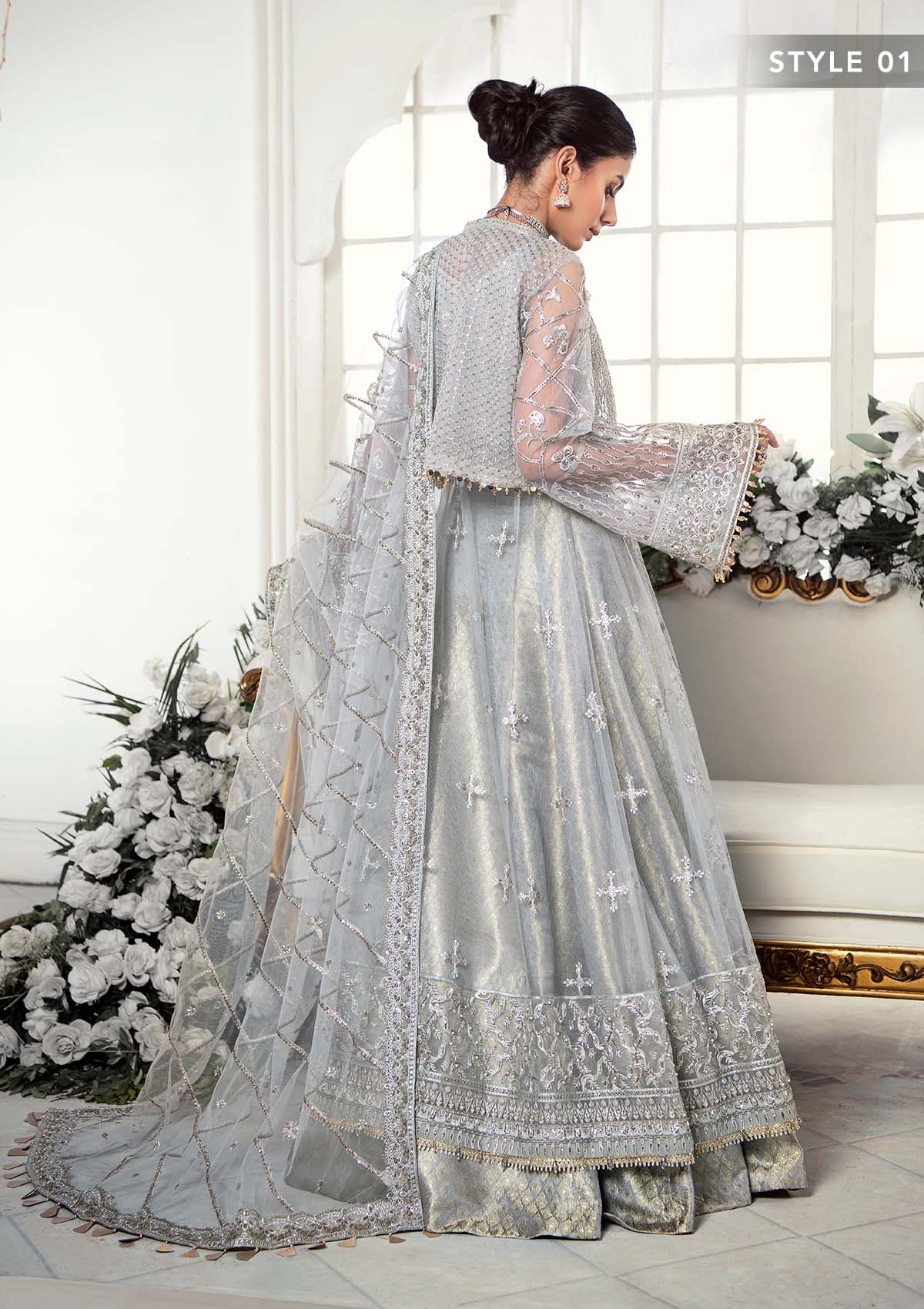 Majestic silver net ensemble featuring sequin-encrusted jaals, crystal embellished details, organza borders, raw silk pants, and an embroidered net dupatta for a timeless feminine luxury look.