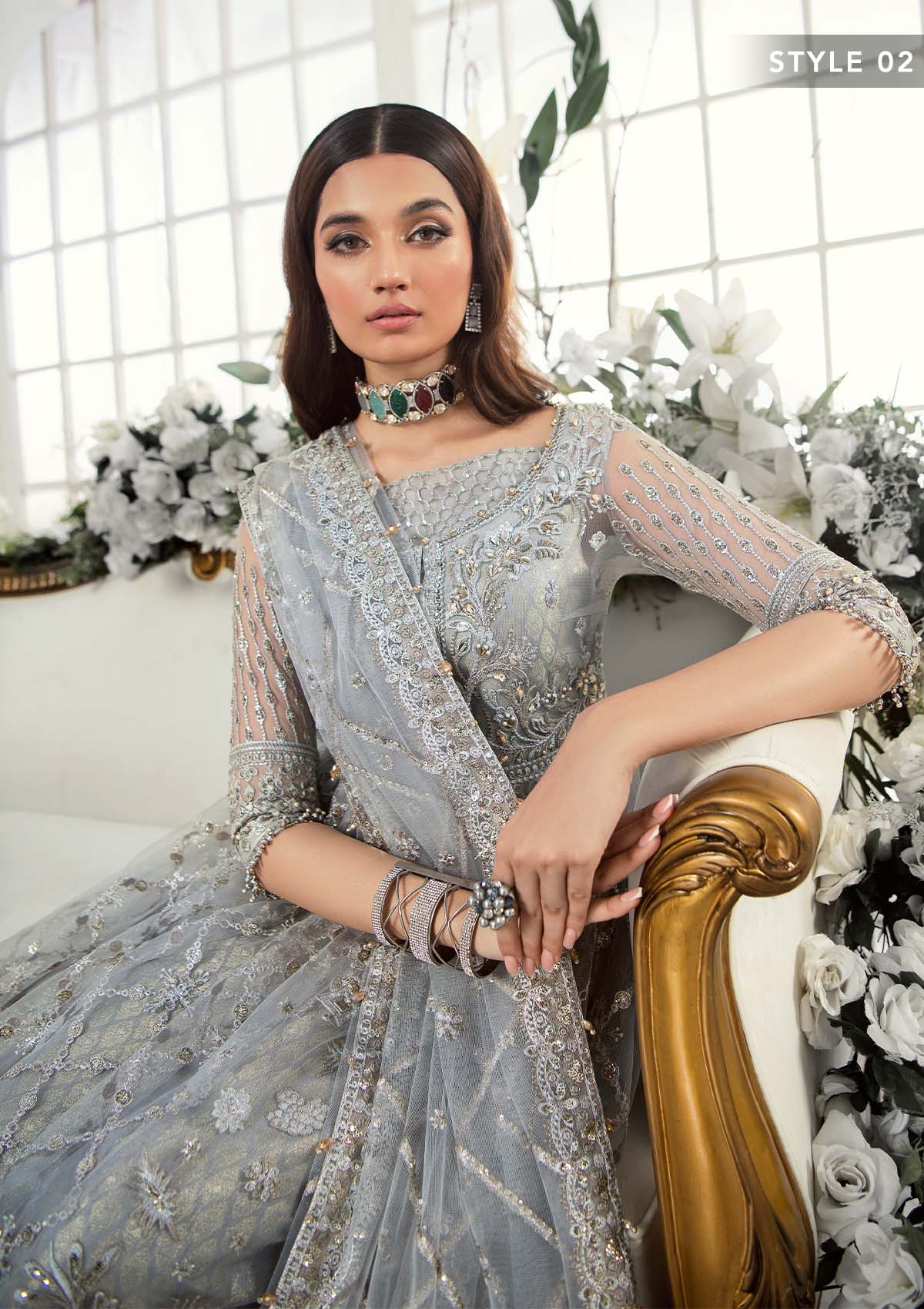 Majestic silver net ensemble featuring sequin-encrusted jaals, crystal embellished details, organza borders, raw silk pants, and an embroidered net dupatta for a timeless feminine luxury look.