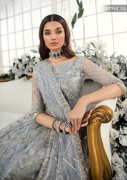 Majestic silver net ensemble featuring sequin-encrusted jaals, crystal embellished details, organza borders, raw silk pants, and an embroidered net dupatta for a timeless feminine luxury look.