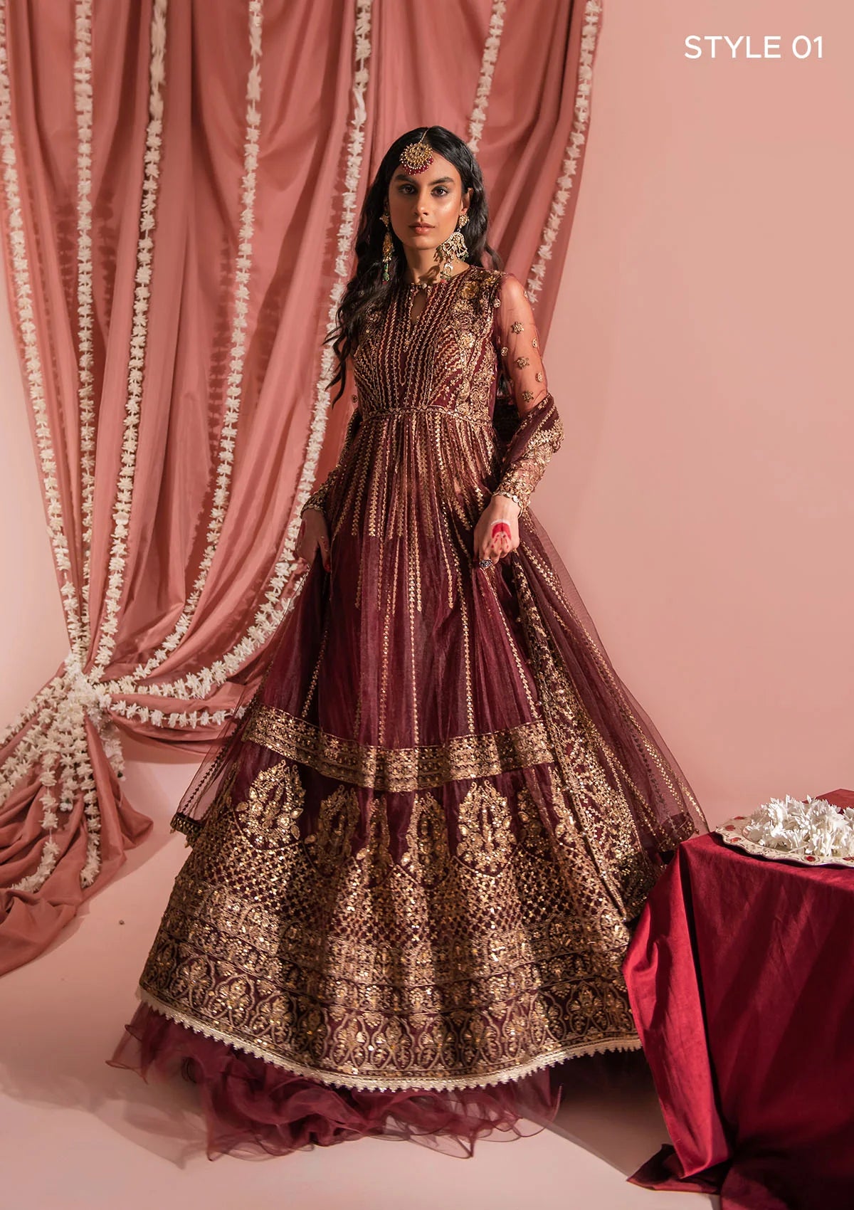 Festive mahogany net ensemble inspired by Kashmiri craftsmanship, featuring oxidised gold and bronze tilla, antique sequins, hand embellishments, masoori silk pants, and an embroidered net dupatta.