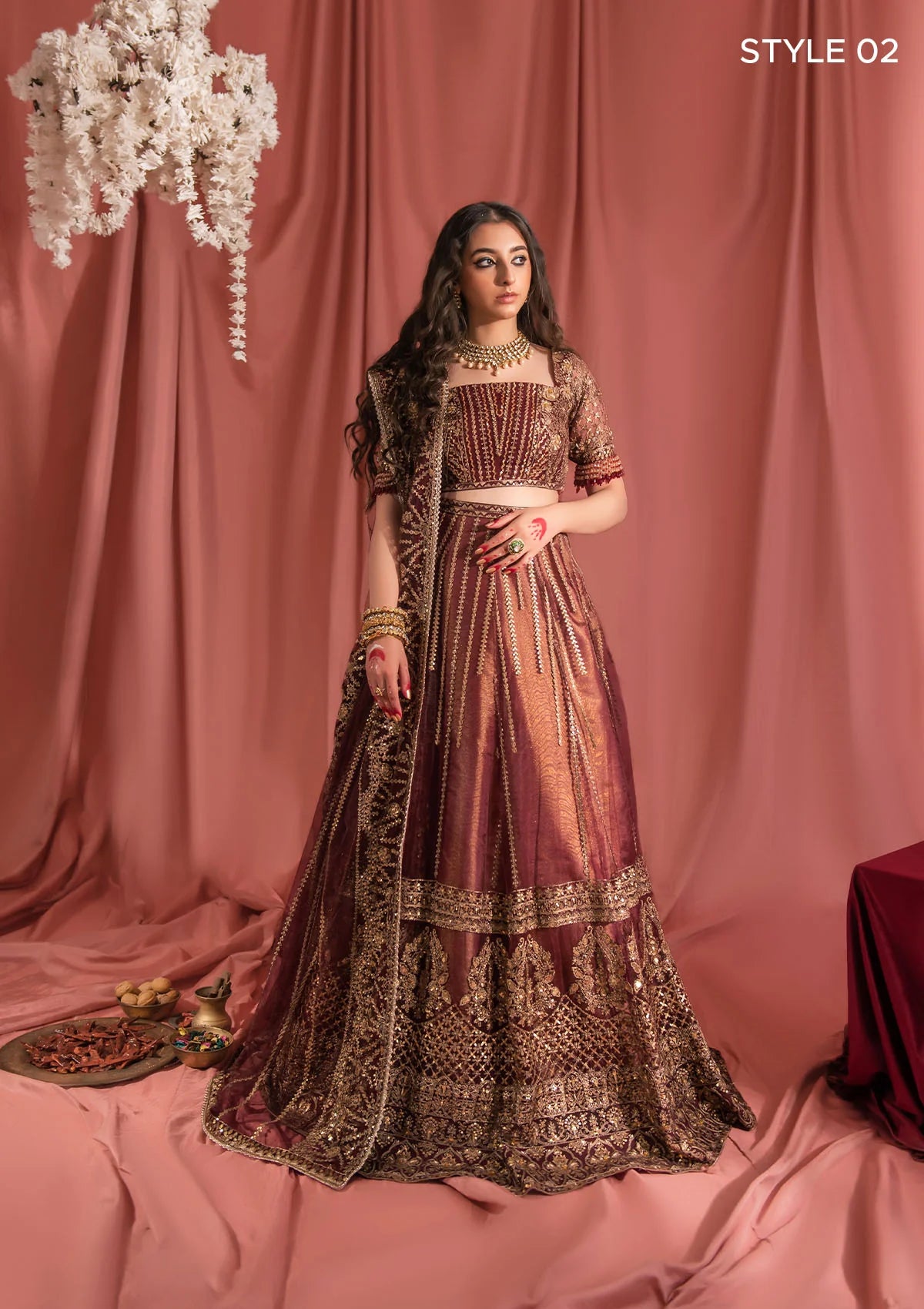 Festive mahogany net ensemble inspired by Kashmiri craftsmanship, featuring oxidised gold and bronze tilla, antique sequins, hand embellishments, masoori silk pants, and an embroidered net dupatta.
