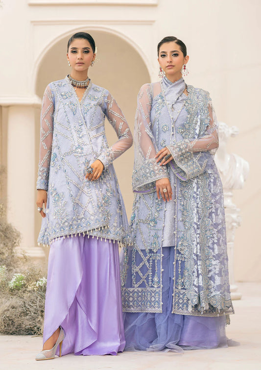 Exquisite lavender net ensemble featuring crystal and pearl embellishments, tilla-infused embroidery, masoori silk pants, and an organza jacquard dupatta. Styled as a short shirt with draped skirt or long shirt with sharara pants.