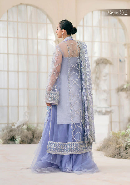 Exquisite lavender net ensemble featuring crystal and pearl embellishments, tilla-infused embroidery, masoori silk pants, and an organza jacquard dupatta. Styled as a short shirt with draped skirt or long shirt with sharara pants.
