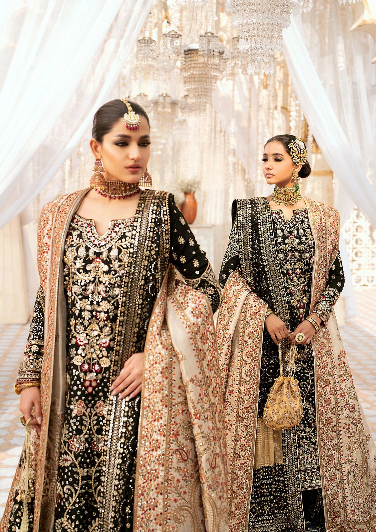 Luxurious medium silk ensemble with intricate embroidery, embellished borders, jamawaar pants, and an embroidered silk dupatta. Styled as a long shirt with gharara or izhaar pants for timeless elegance.