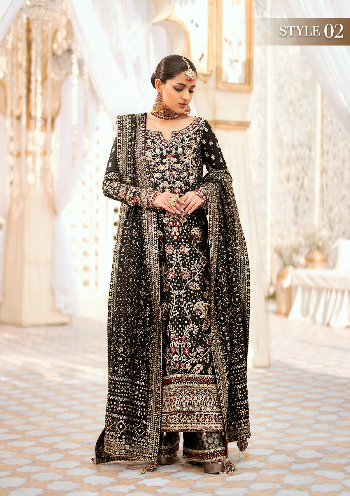 Luxurious medium silk ensemble with intricate embroidery, embellished borders, jamawaar pants, and an embroidered silk dupatta. Styled as a long shirt with gharara or izhaar pants for timeless elegance.