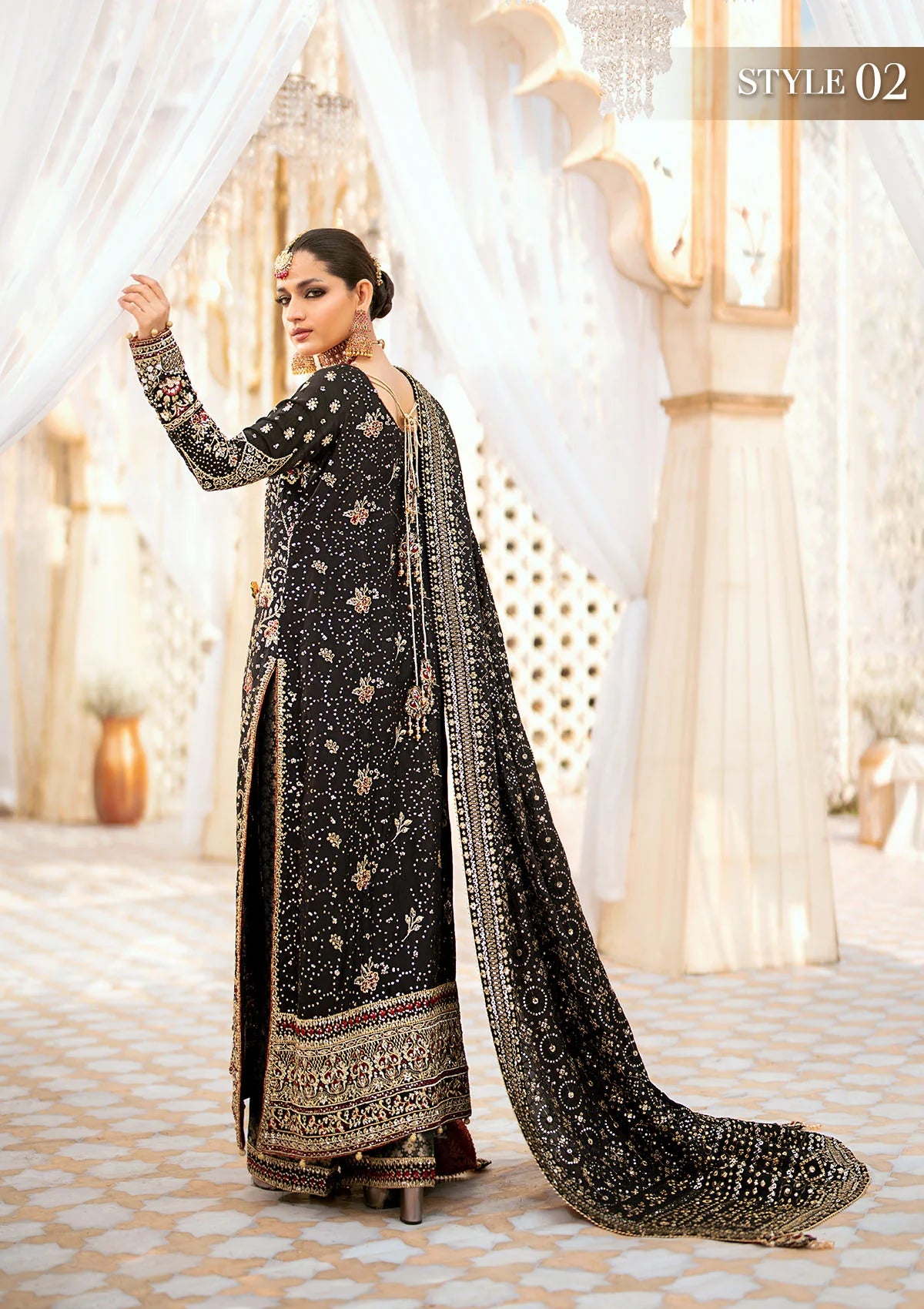 Luxurious medium silk ensemble with intricate embroidery, embellished borders, jamawaar pants, and an embroidered silk dupatta. Styled as a long shirt with gharara or izhaar pants for timeless elegance.
