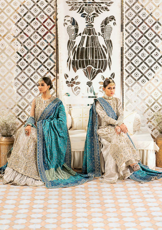 Elegant embroidered net suit featuring organza borders, jamawaar pants, and a medium silk dupatta with detailed embroidery for festive wear occasions!