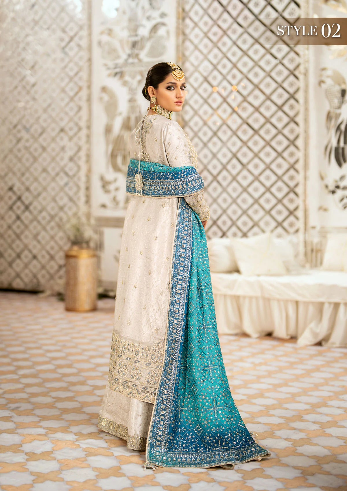 Elegant embroidered net suit featuring organza borders, jamawaar pants, and a medium silk dupatta with detailed embroidery for festive wear occasions!