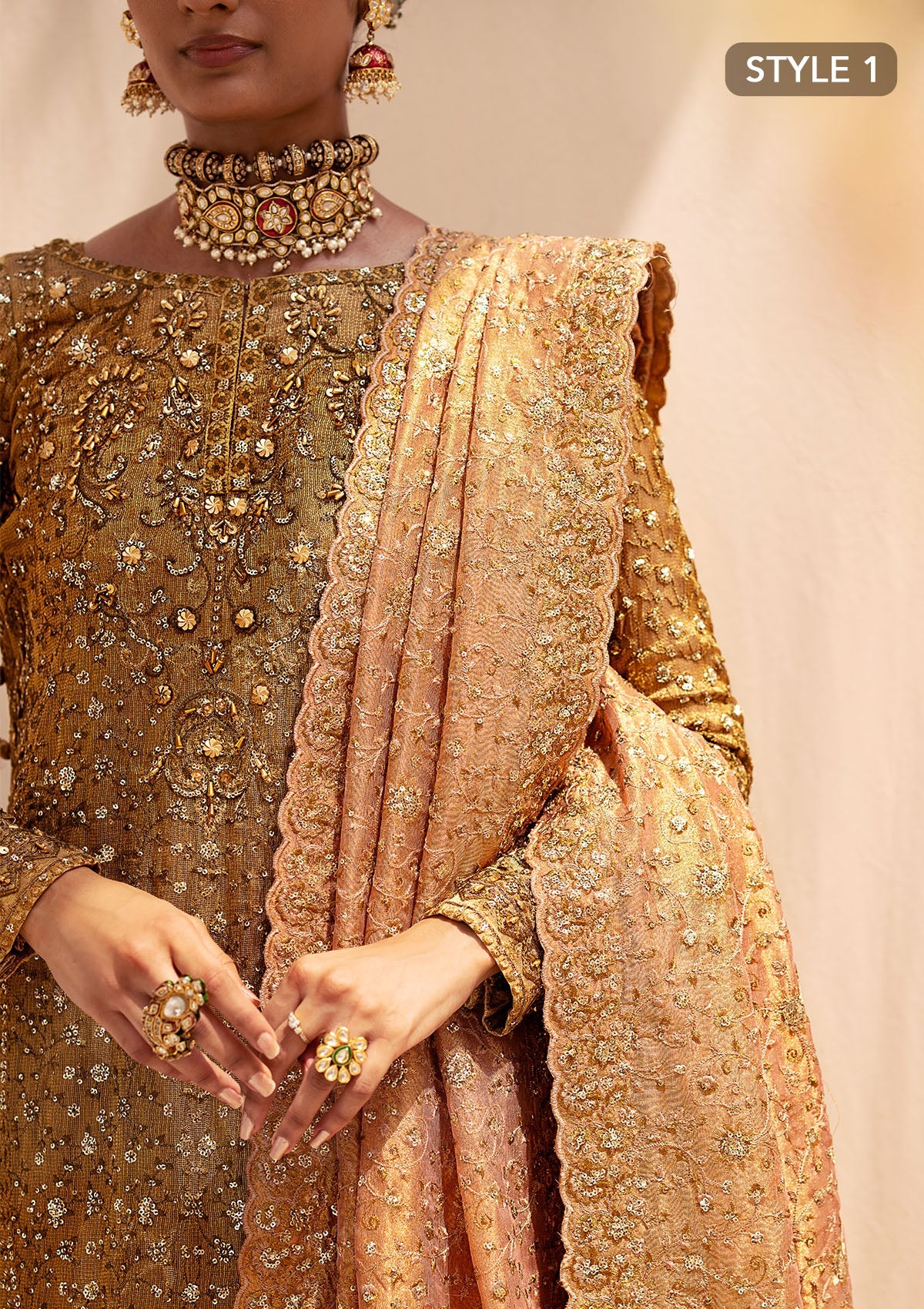 Opulent kundan zari ensemble with rich embroidery, tissue borders, masoori silk pants, and an embroidered tissue dupatta. Styled as a long shirt with crushed frock or farshi gharara for regal elegance.