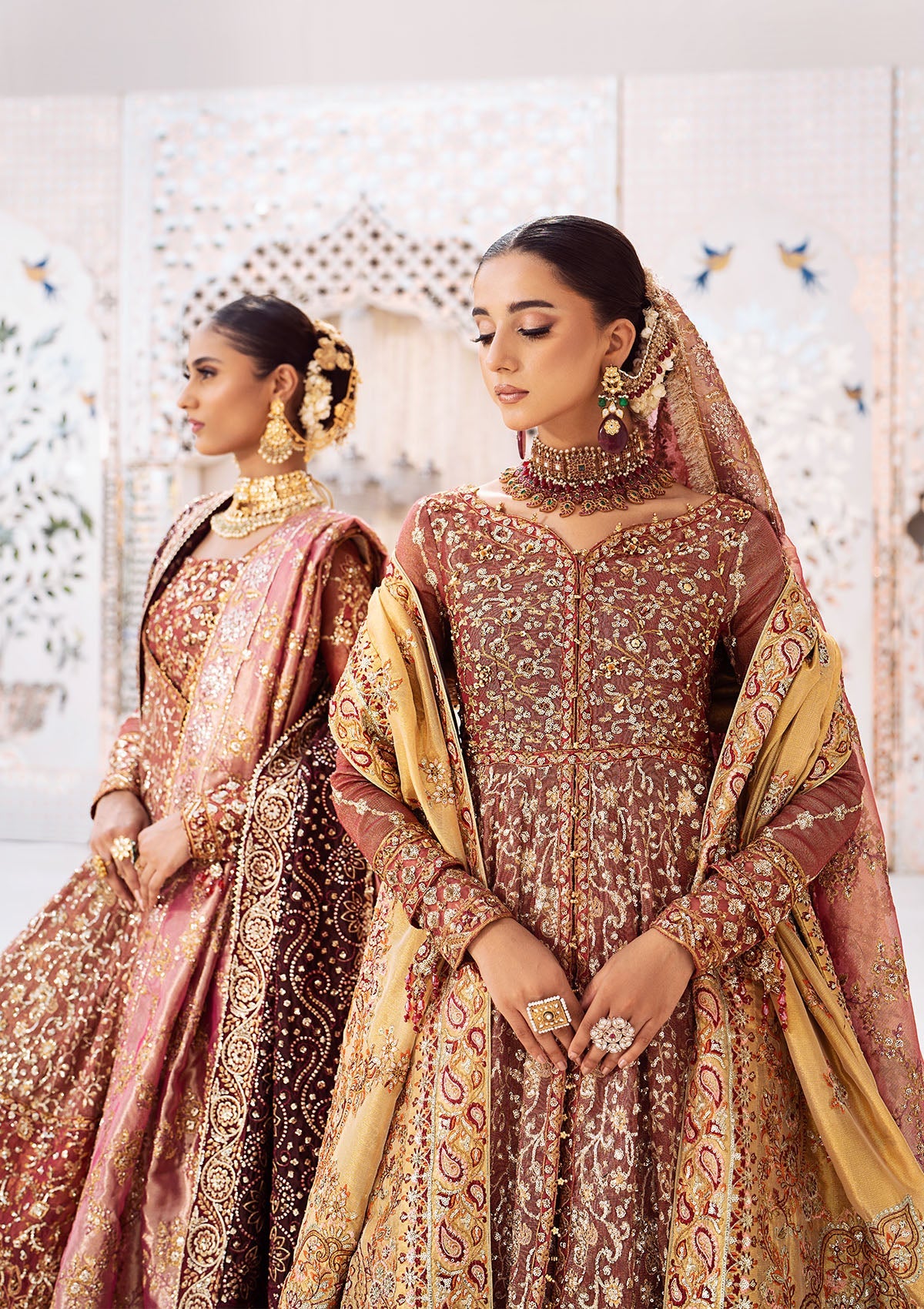 Graceful zari net ensemble with embellished bodice, organza borders, masoori silk pants, and an embroidered tissue dupatta. Styled as kalidaar frock with crushed farshi lehnga or angrakha with crushed sharara.