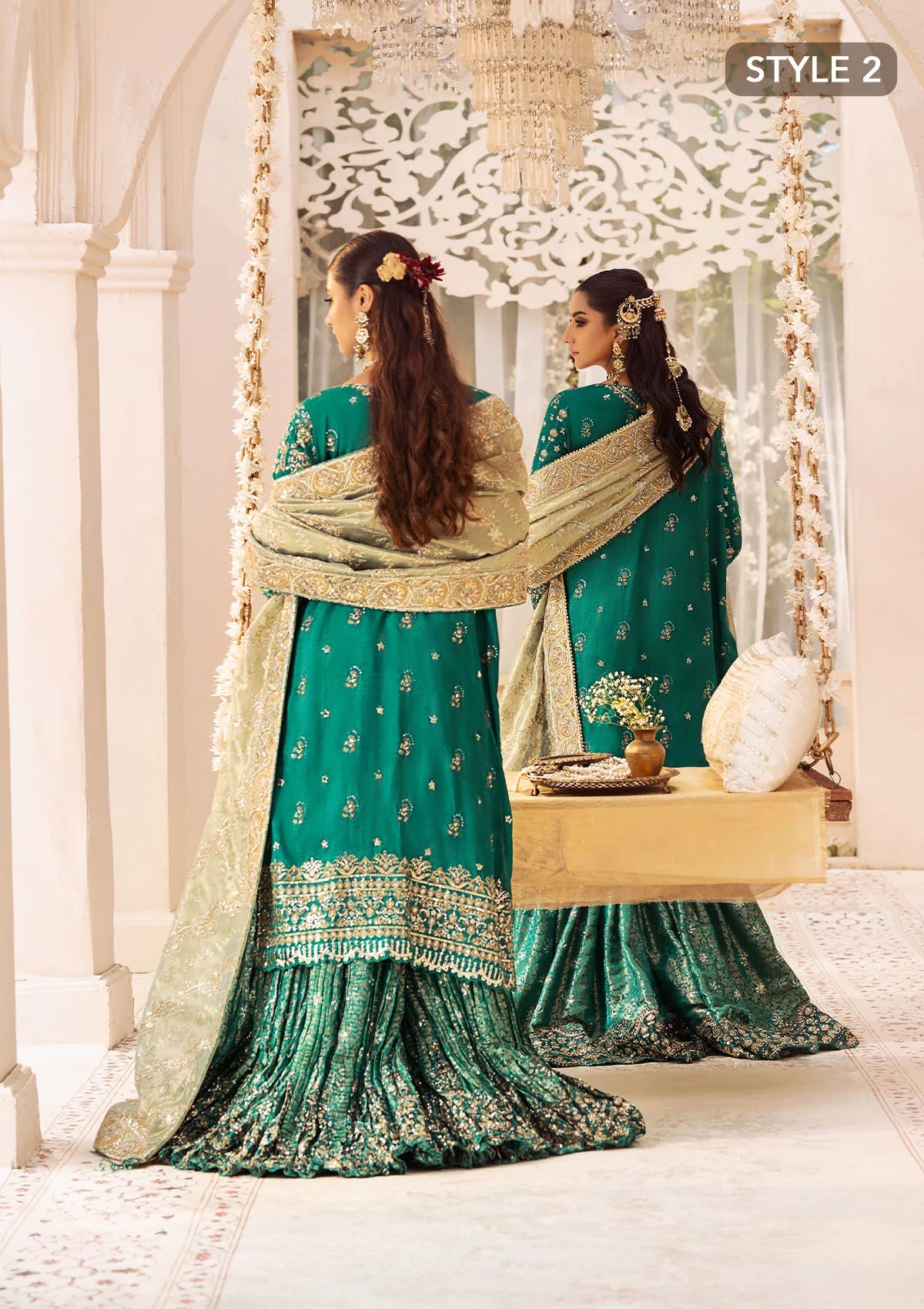 Elegant medium silk ensemble with detailed embroidery, layered borders, jamawaar pants, and a tissue dupatta. Styled as a mid-length shirt with crushed sharara or classic gharara for festive occasions.