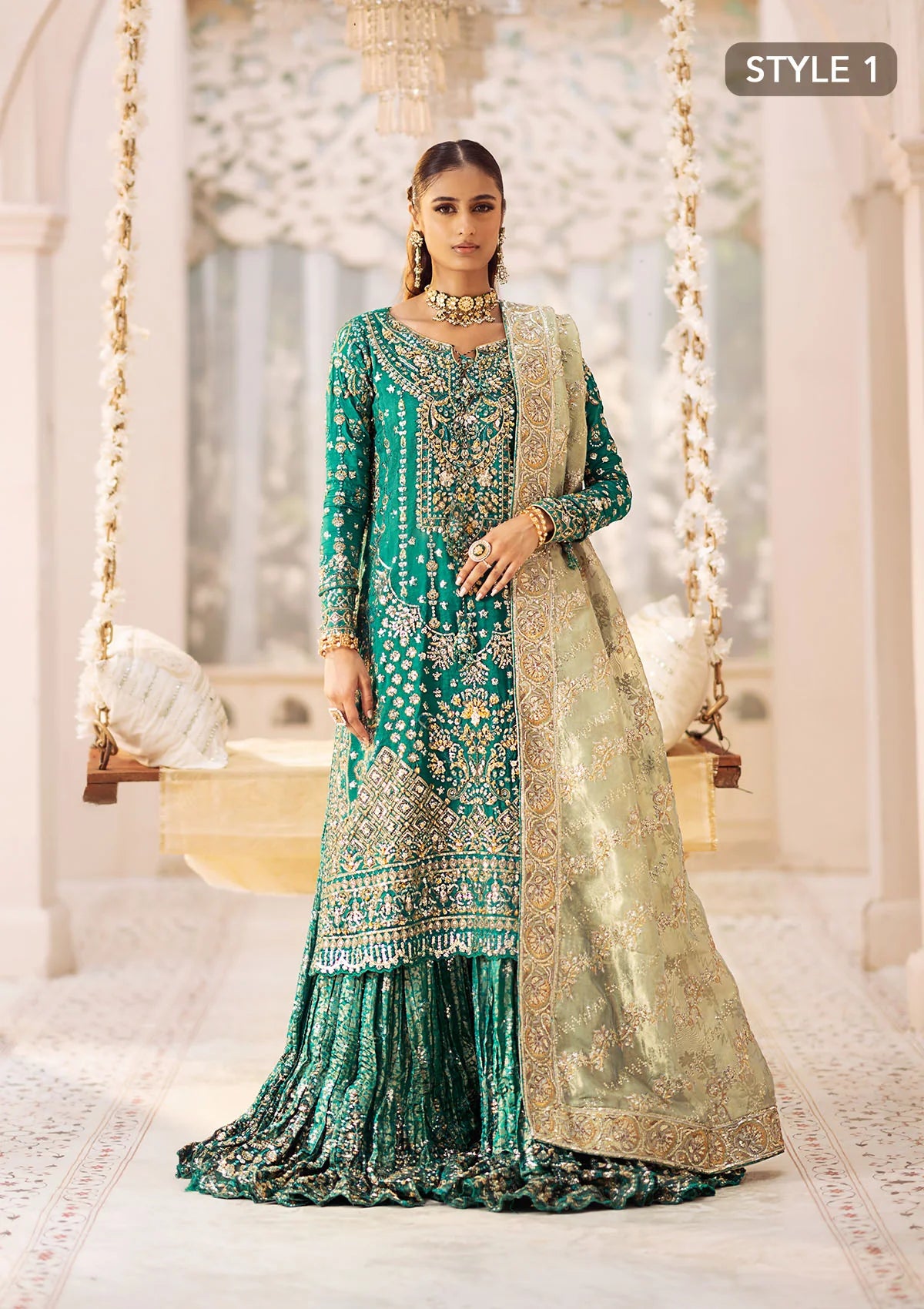 Elegant medium silk ensemble with detailed embroidery, layered borders, jamawaar pants, and a tissue dupatta. Styled as a mid-length shirt with crushed sharara or classic gharara for festive occasions.