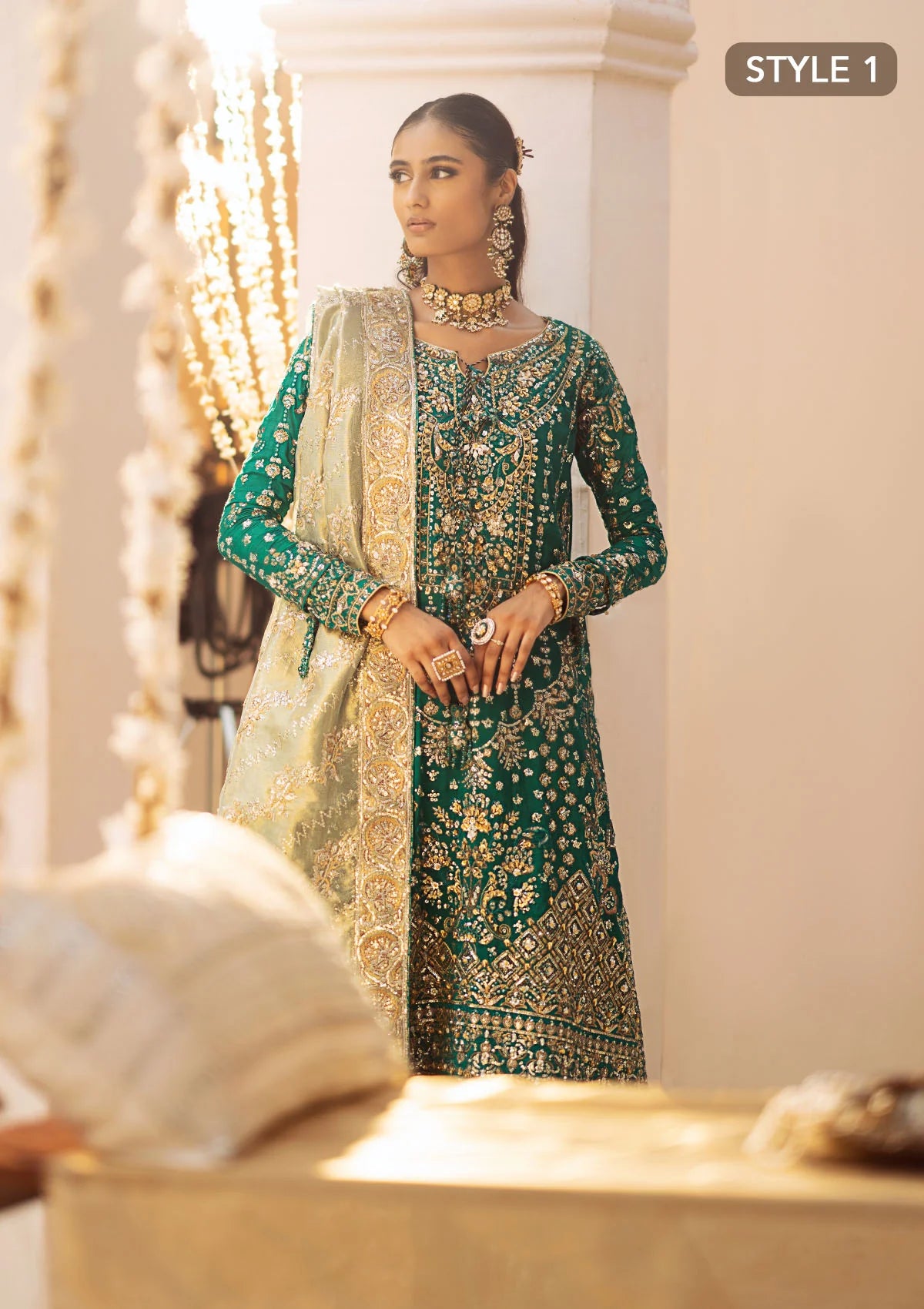 Elegant medium silk ensemble with detailed embroidery, layered borders, jamawaar pants, and a tissue dupatta. Styled as a mid-length shirt with crushed sharara or classic gharara for festive occasions.