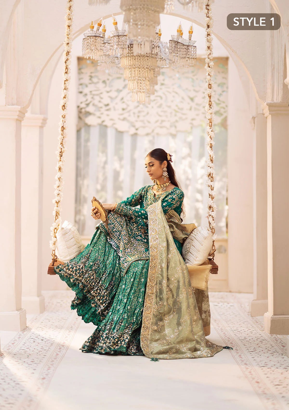 Elegant medium silk ensemble with detailed embroidery, layered borders, jamawaar pants, and a tissue dupatta. Styled as a mid-length shirt with crushed sharara or classic gharara for festive occasions.