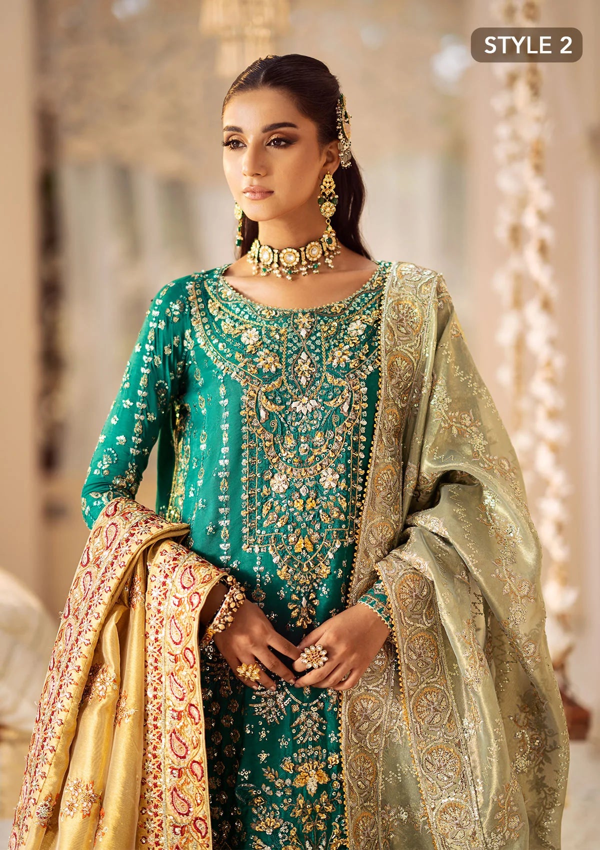 Elegant medium silk ensemble with detailed embroidery, layered borders, jamawaar pants, and a tissue dupatta. Styled as a mid-length shirt with crushed sharara or classic gharara for festive occasions.