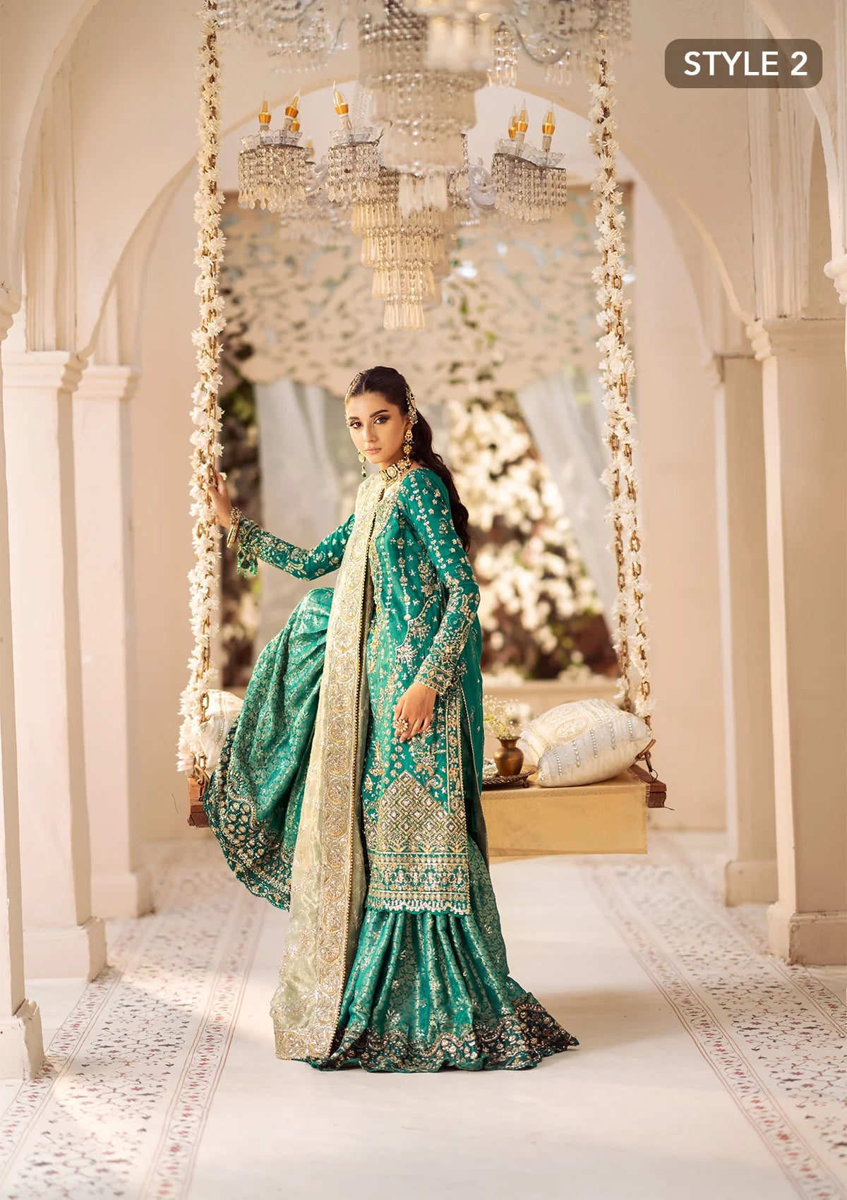 Elegant medium silk ensemble with detailed embroidery, layered borders, jamawaar pants, and a tissue dupatta. Styled as a mid-length shirt with crushed sharara or classic gharara for festive occasions.