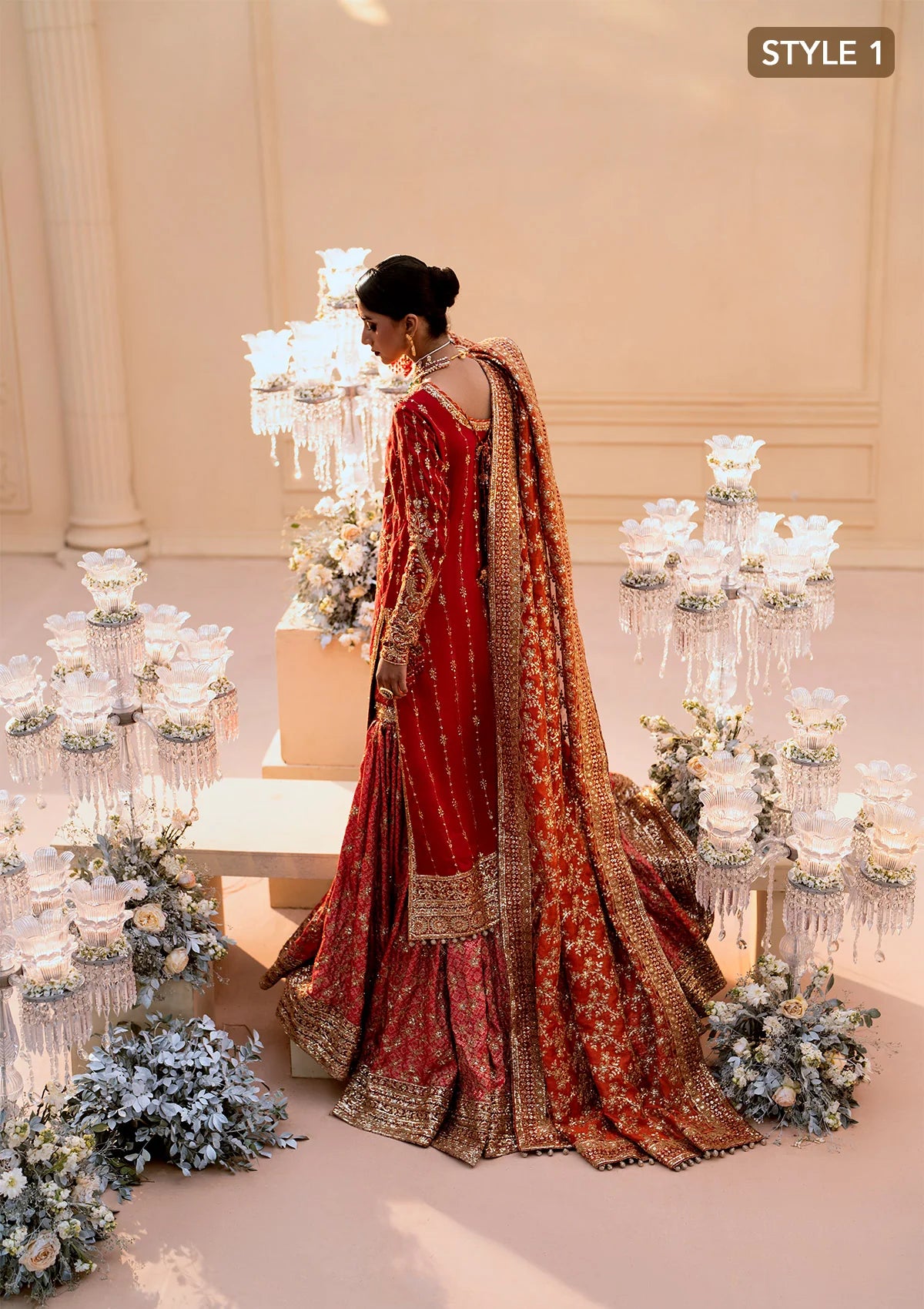 Elegant medium silk ensemble with rich embroidery, embellished borders, embroidered jamawaar pants, and a tissue dupatta. Styled as a long shirt with farshi gharara or crushed gharara for festive wear.
