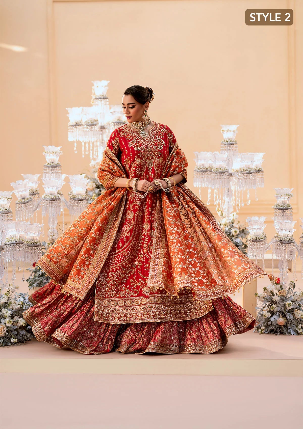 Elegant medium silk ensemble with rich embroidery, embellished borders, embroidered jamawaar pants, and a tissue dupatta. Styled as a long shirt with farshi gharara or crushed gharara for festive wear.