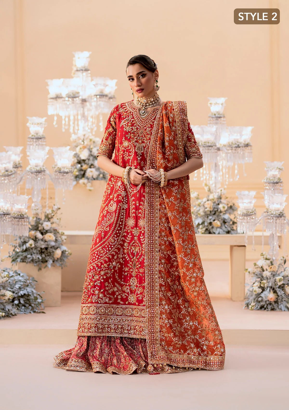 Elegant medium silk ensemble with rich embroidery, embellished borders, embroidered jamawaar pants, and a tissue dupatta. Styled as a long shirt with farshi gharara or crushed gharara for festive wear.