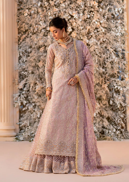 Elegant khaadi net ensemble with embellished organza neckline, detailed borders, masoori silk pants, and chiffon dupatta. Styled as angrakha with gharara or side-slit long shirt with crushed frock.