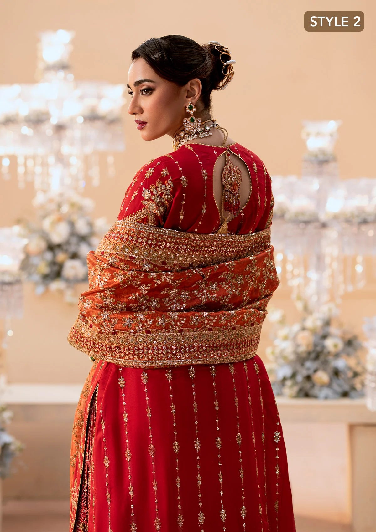Elegant medium silk ensemble with rich embroidery, embellished borders, embroidered jamawaar pants, and a tissue dupatta. Styled as a long shirt with farshi gharara or crushed gharara for festive wear.