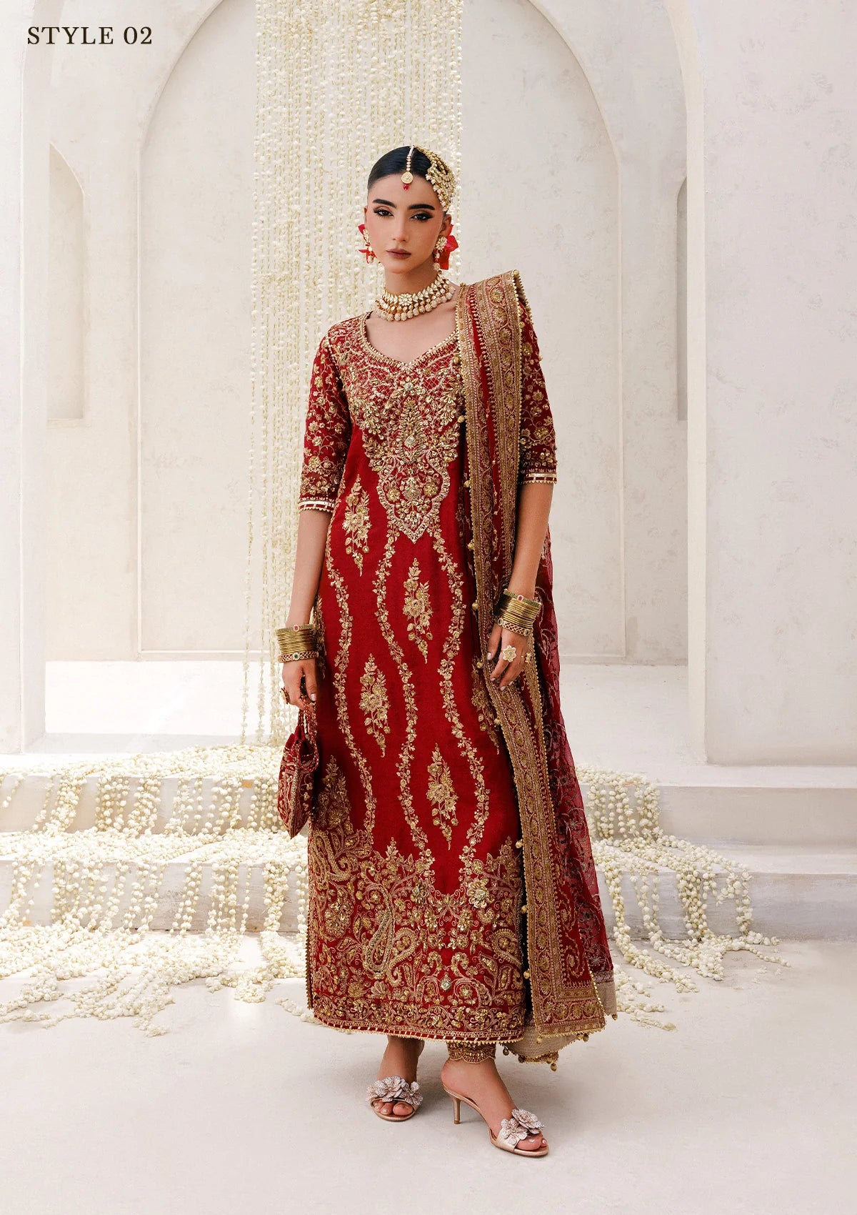 Graceful khaadi net ensemble with embellished neckline, detailed hem patches, organza borders, masoori silk pants, and a chiffon dupatta. Styled as a long shirt with farshi gharara or Hyderabadi shirt with churi pajama.