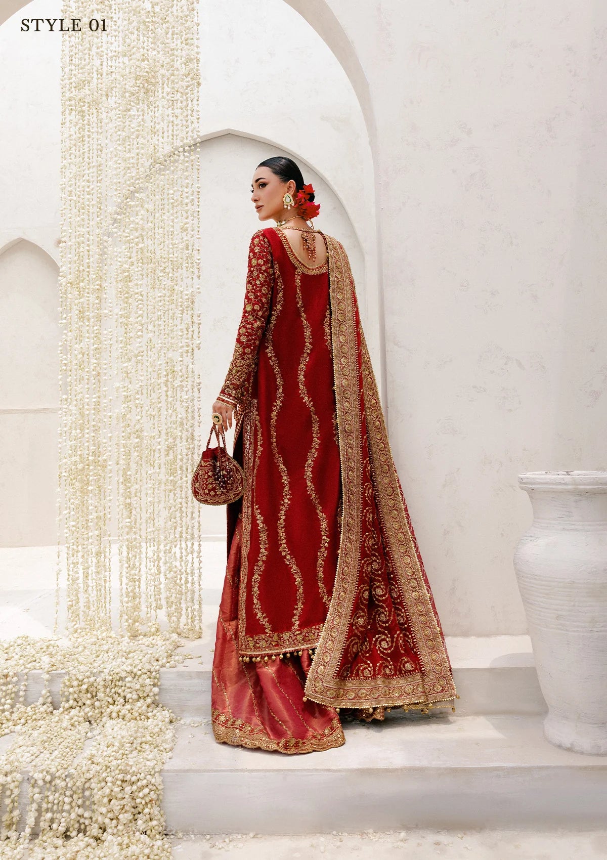 Graceful khaadi net ensemble with embellished neckline, detailed hem patches, organza borders, masoori silk pants, and a chiffon dupatta. Styled as a long shirt with farshi gharara or Hyderabadi shirt with churi pajama.