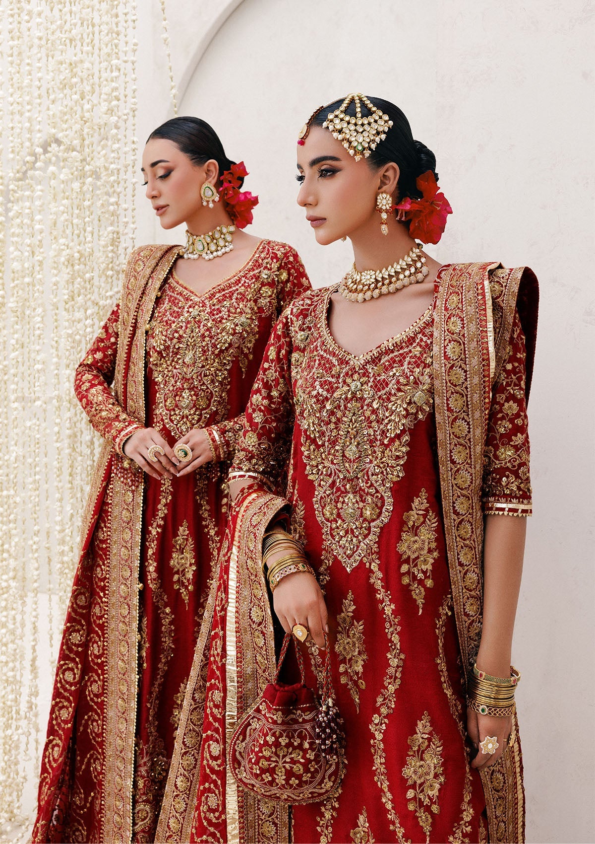 Graceful khaadi net ensemble with embellished neckline, detailed hem patches, organza borders, masoori silk pants, and a chiffon dupatta. Styled as a long shirt with farshi gharara or Hyderabadi shirt with churi pajama.