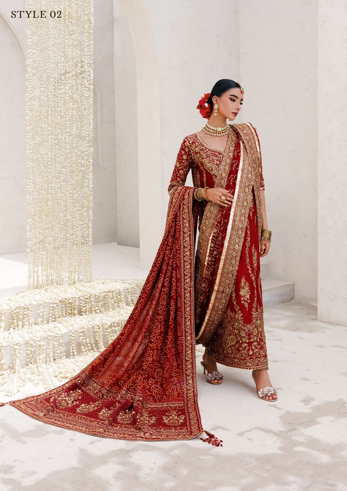 Graceful khaadi net ensemble with embellished neckline, detailed hem patches, organza borders, masoori silk pants, and a chiffon dupatta. Styled as a long shirt with farshi gharara or Hyderabadi shirt with churi pajama.