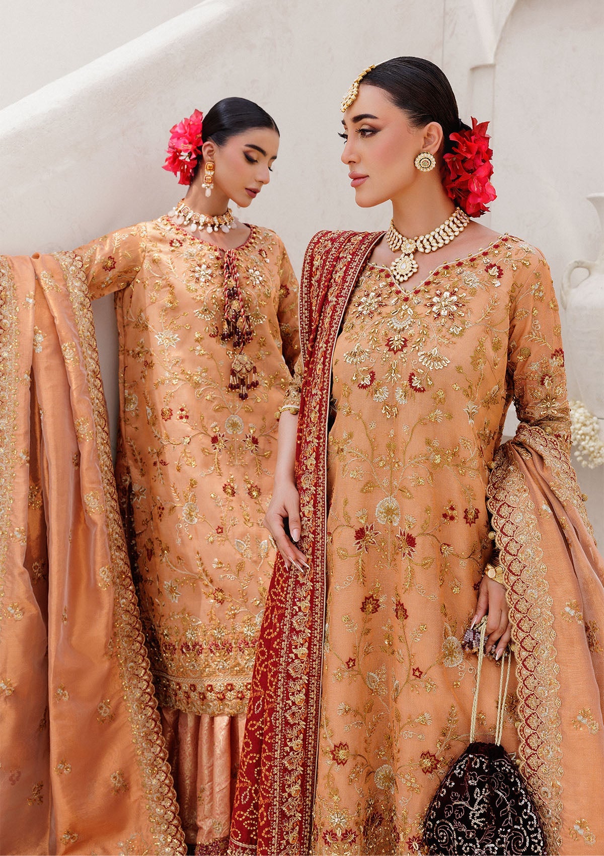 Luxurious tissue ensemble with rich embroidery, embellished borders, jamawar pants, and an embroidered tissue dupatta. Styled as a long shirt with farshi gharara or elegant skirt.