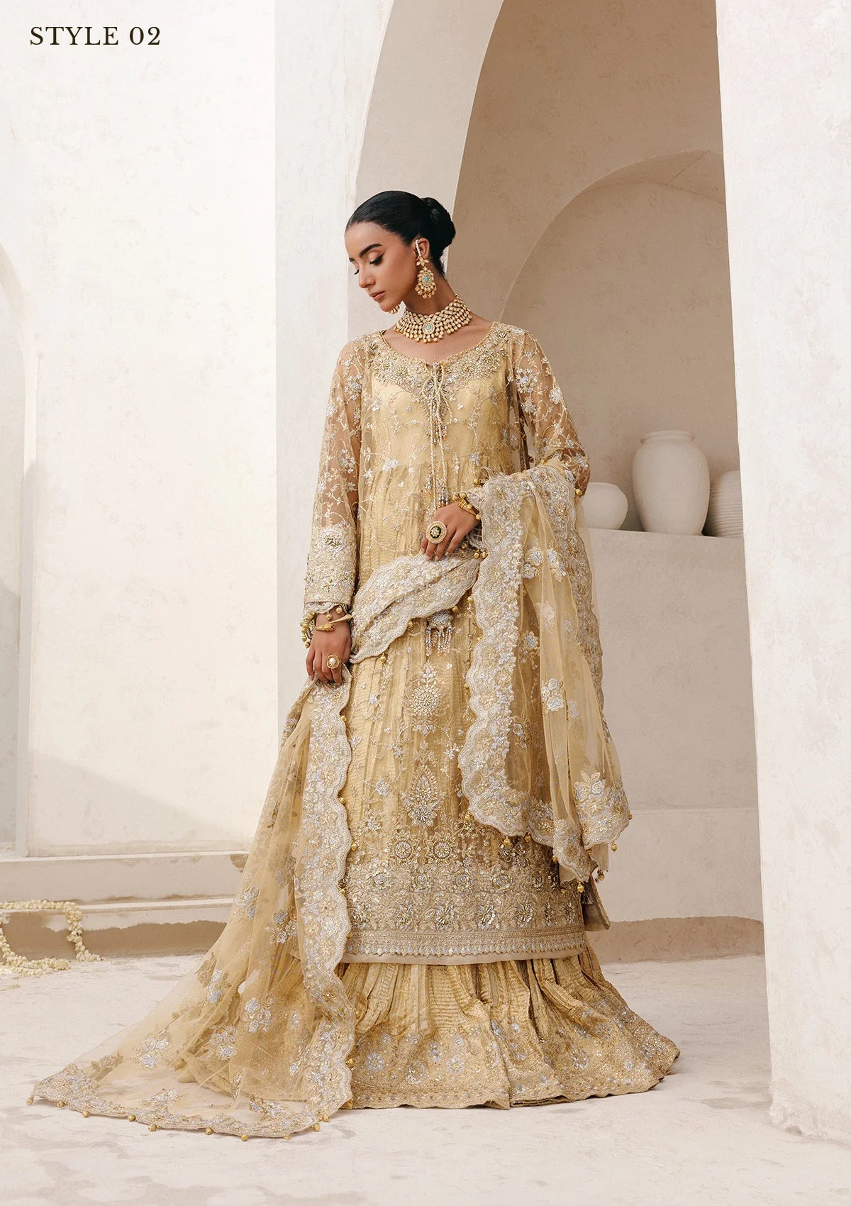 Elegant embroidered net ensemble with tissue neckline, rich borders, jamawar pants, and an embroidered net dupatta. Styled as a long shirt with farshi gharara or side-slit long shirt with crushed frock.