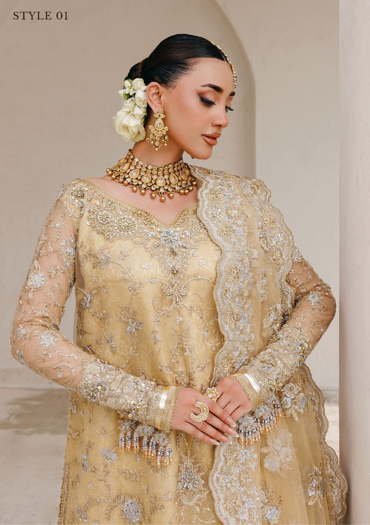 Elegant embroidered net ensemble with tissue neckline, rich borders, jamawar pants, and an embroidered net dupatta. Styled as a long shirt with farshi gharara or side-slit long shirt with crushed frock.