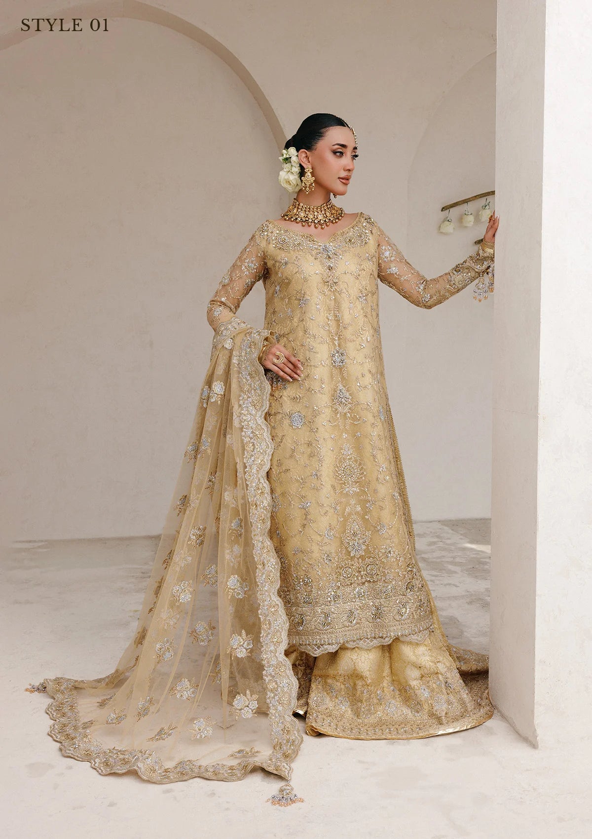 Elegant embroidered net ensemble with tissue neckline, rich borders, jamawar pants, and an embroidered net dupatta. Styled as a long shirt with farshi gharara or side-slit long shirt with crushed frock.