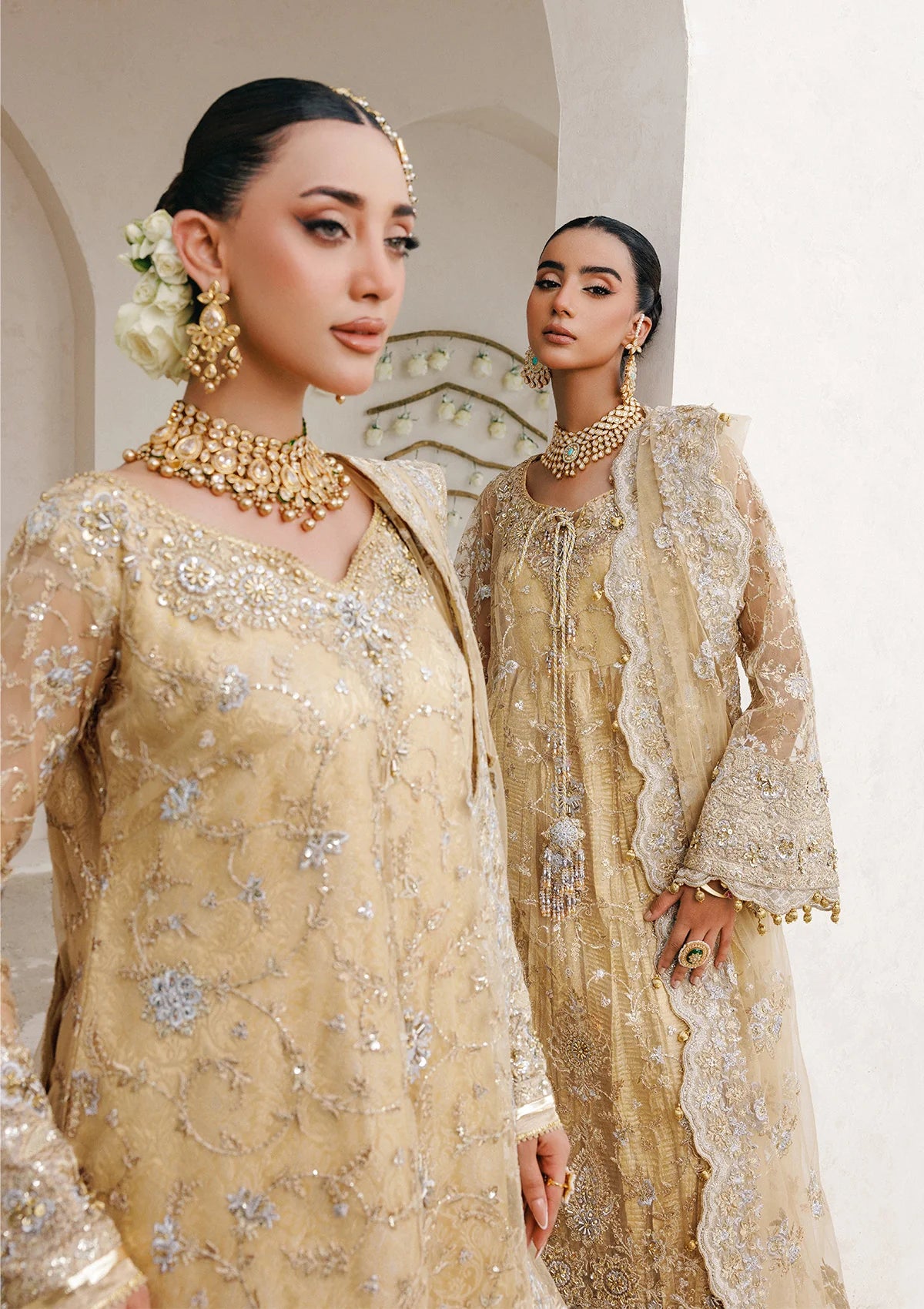 Elegant embroidered net ensemble with tissue neckline, rich borders, jamawar pants, and an embroidered net dupatta. Styled as a long shirt with farshi gharara or side-slit long shirt with crushed frock.